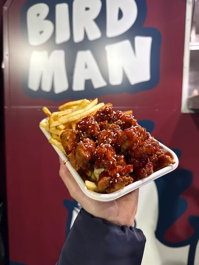 Korean fried chicken tossed in a glossy Korean glaze, loaded over fries, served from The Food Hub's Birdman truck