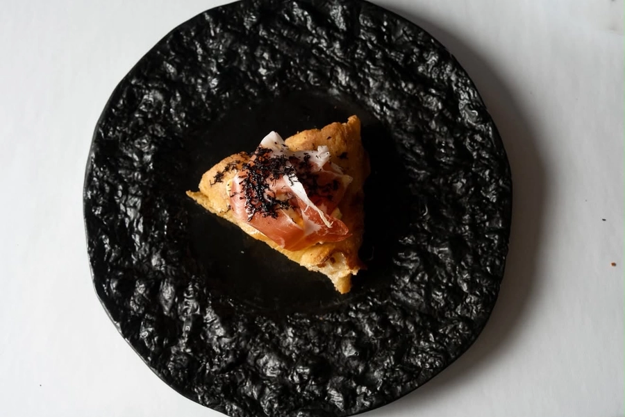Prosciutto and shaved truffle pizza slice, The Food Hub pizza catering